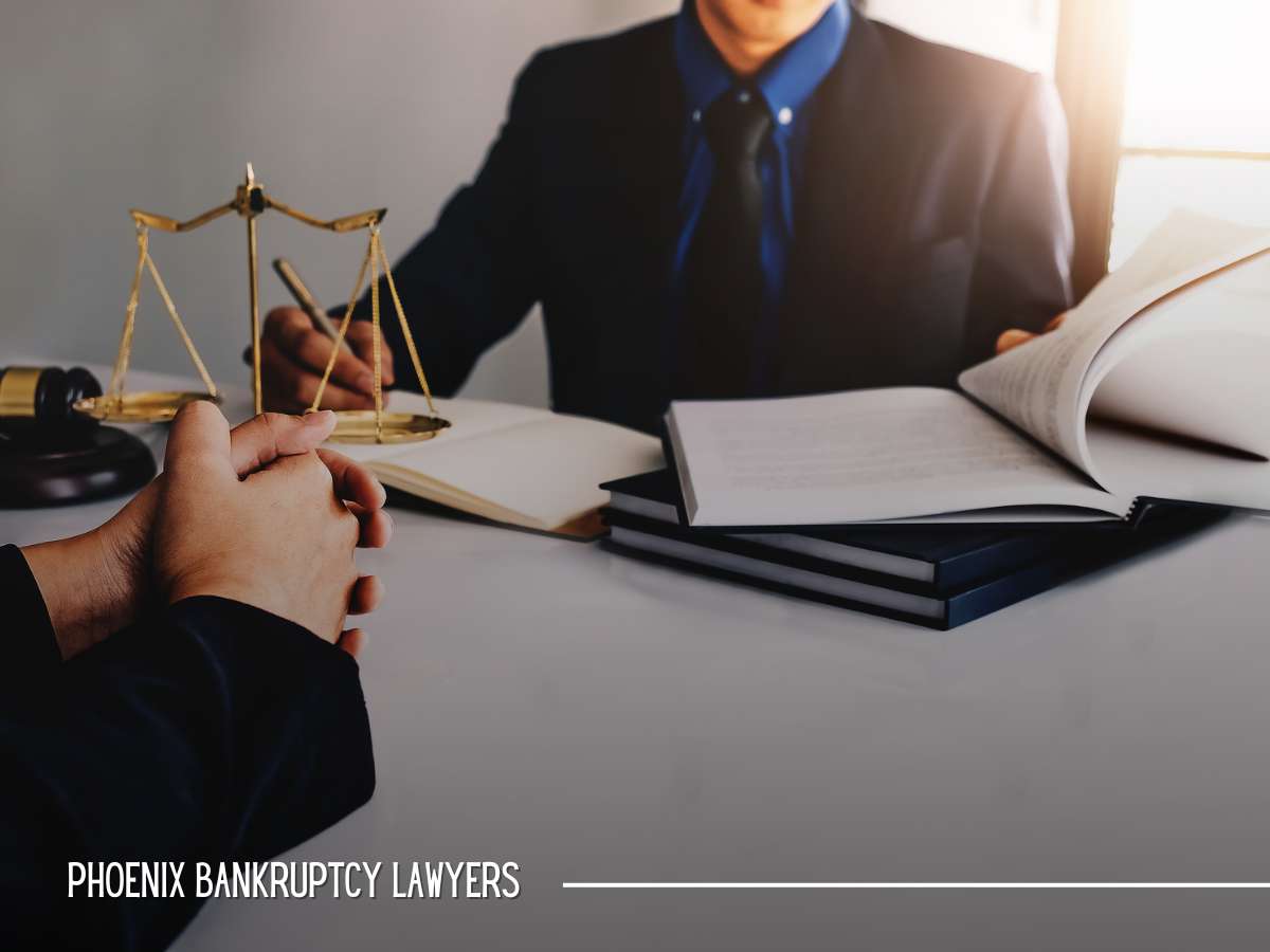Lawyer consulting with client in office with the scales of justice, indicating bankruptcy legal services.